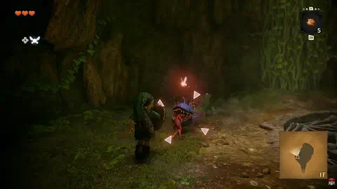 Link with shield raised, locked onto a Deku Baba inside the Great Deku Tree; four pink reticle corners surround the enemy and Navi glows orange above it