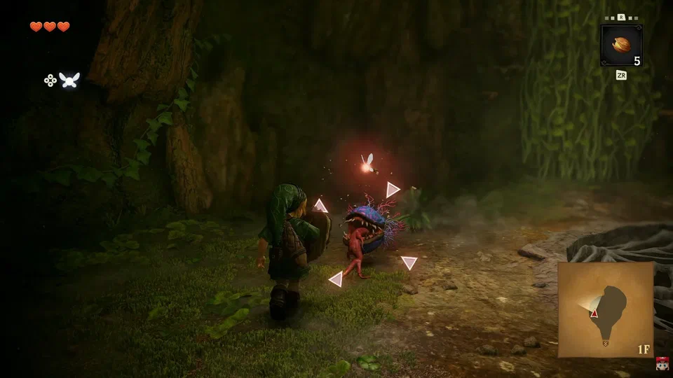 Link with shield raised, locked onto a Deku Baba inside the Great Deku Tree; four pink reticle corners surround the enemy and Navi glows orange above it
