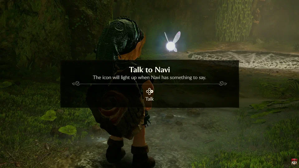 Inside the Great Deku Tree, a tutorial box reads: Talk to Navi. The icon will light up when Navi has something to say. A D-pad icon shows Talk mapped to right.
