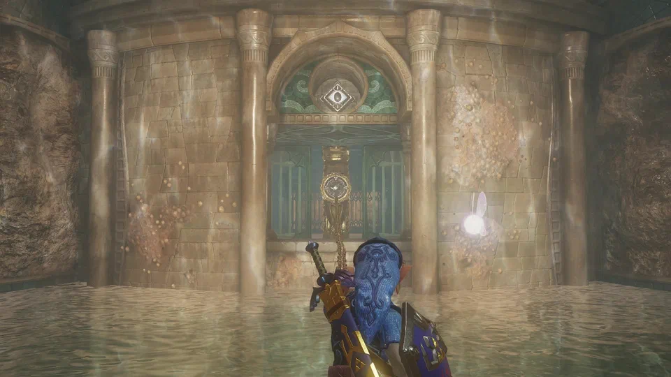 Adult Link in the blue Zora Tunic with the Hylian Shield, waist-deep in water, firing the Hookshot at a golden target mounted above a doorway sealed with an iron gate; a teal mosaic with an eye emblem sits above the arch